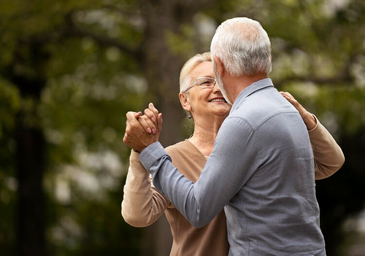 medium shot senior couple dancing nature